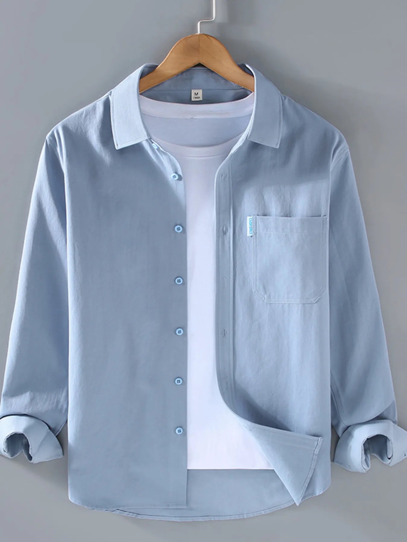 Model wearing plus size long sleeve button-up shirt styled casually