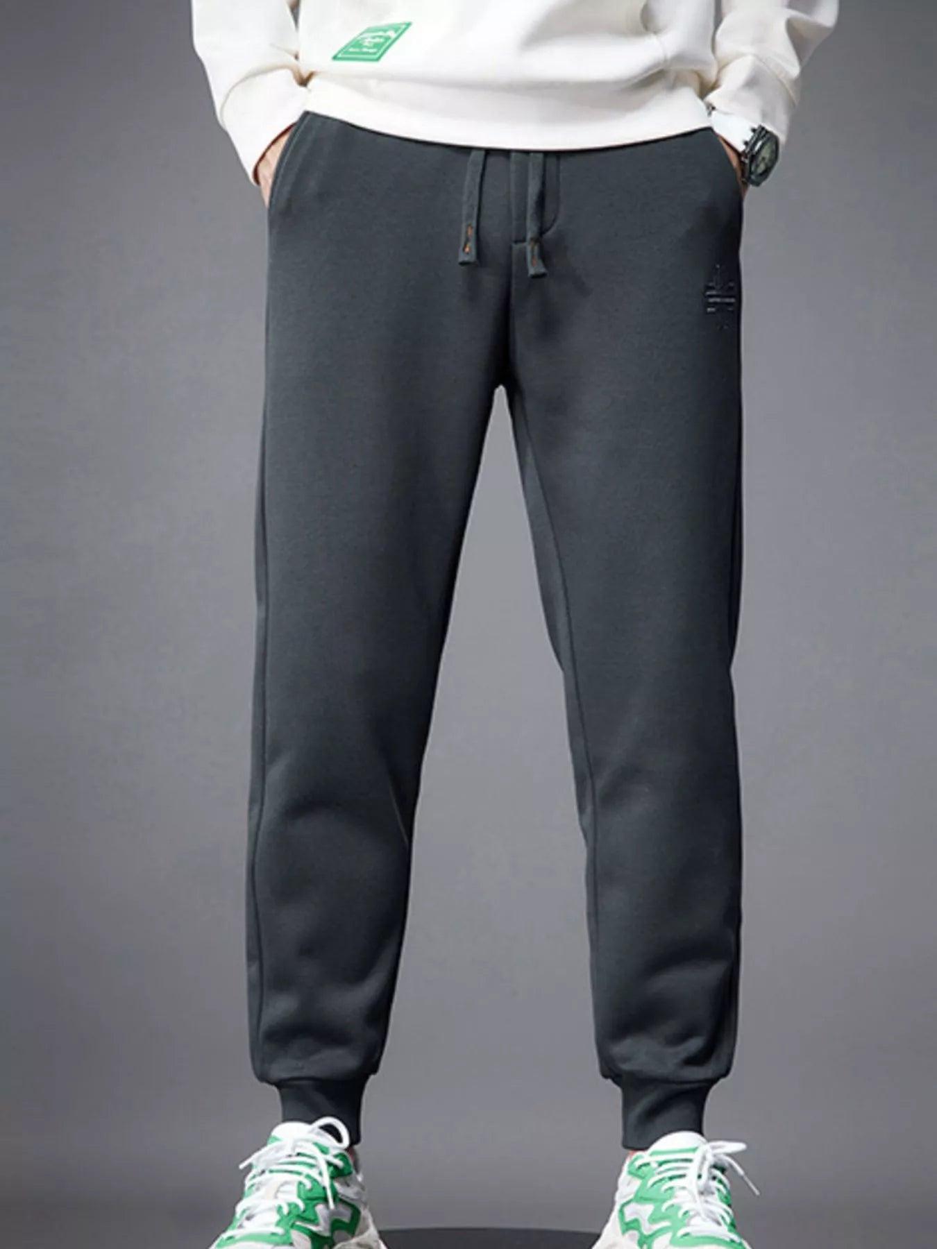 Close-up of pocket and drawstring detail on jogger pants