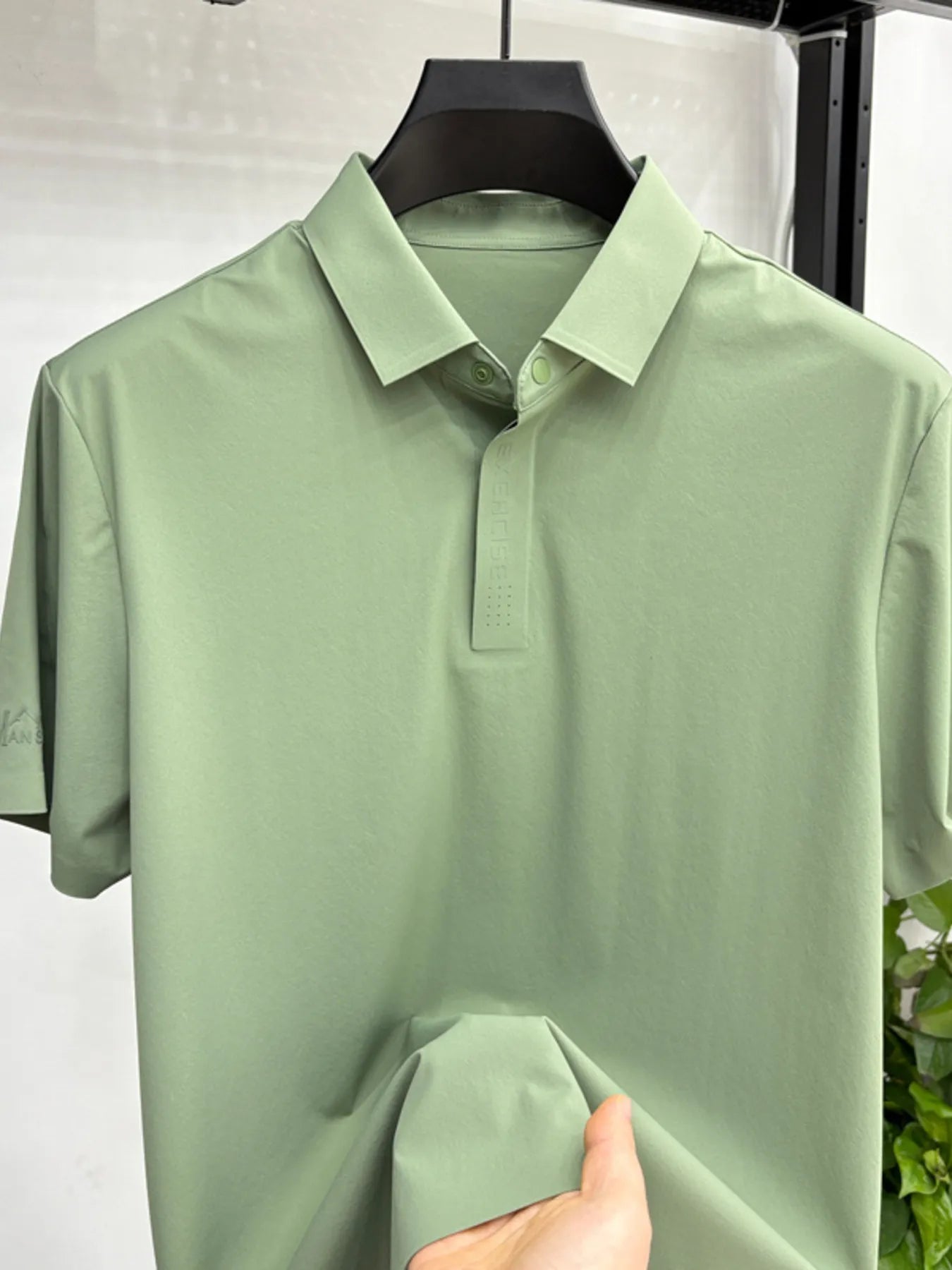Close-up of button polo collar detail on lightweight short sleeve shirt