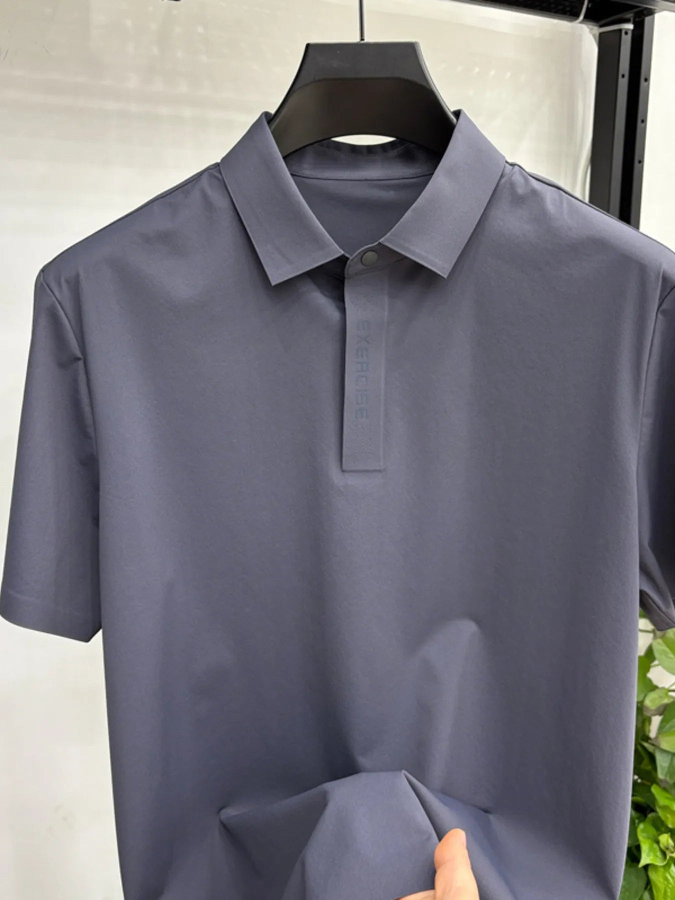 Model wearing lightweight button short sleeve polo shirt styled casually