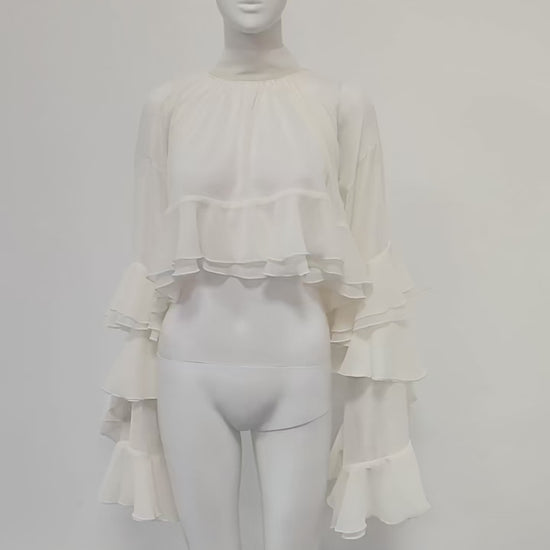 Lifestyle video showing ethereal high-neck sheer ruffled blouse in motion, highlighting folds, ruffles, and elegance