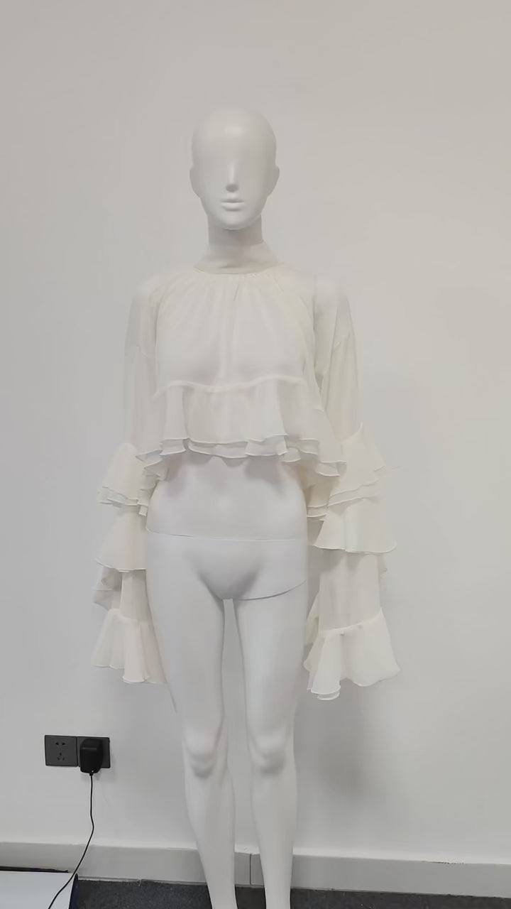 Lifestyle video showing ethereal high-neck sheer ruffled blouse in motion, highlighting folds, ruffles, and elegance