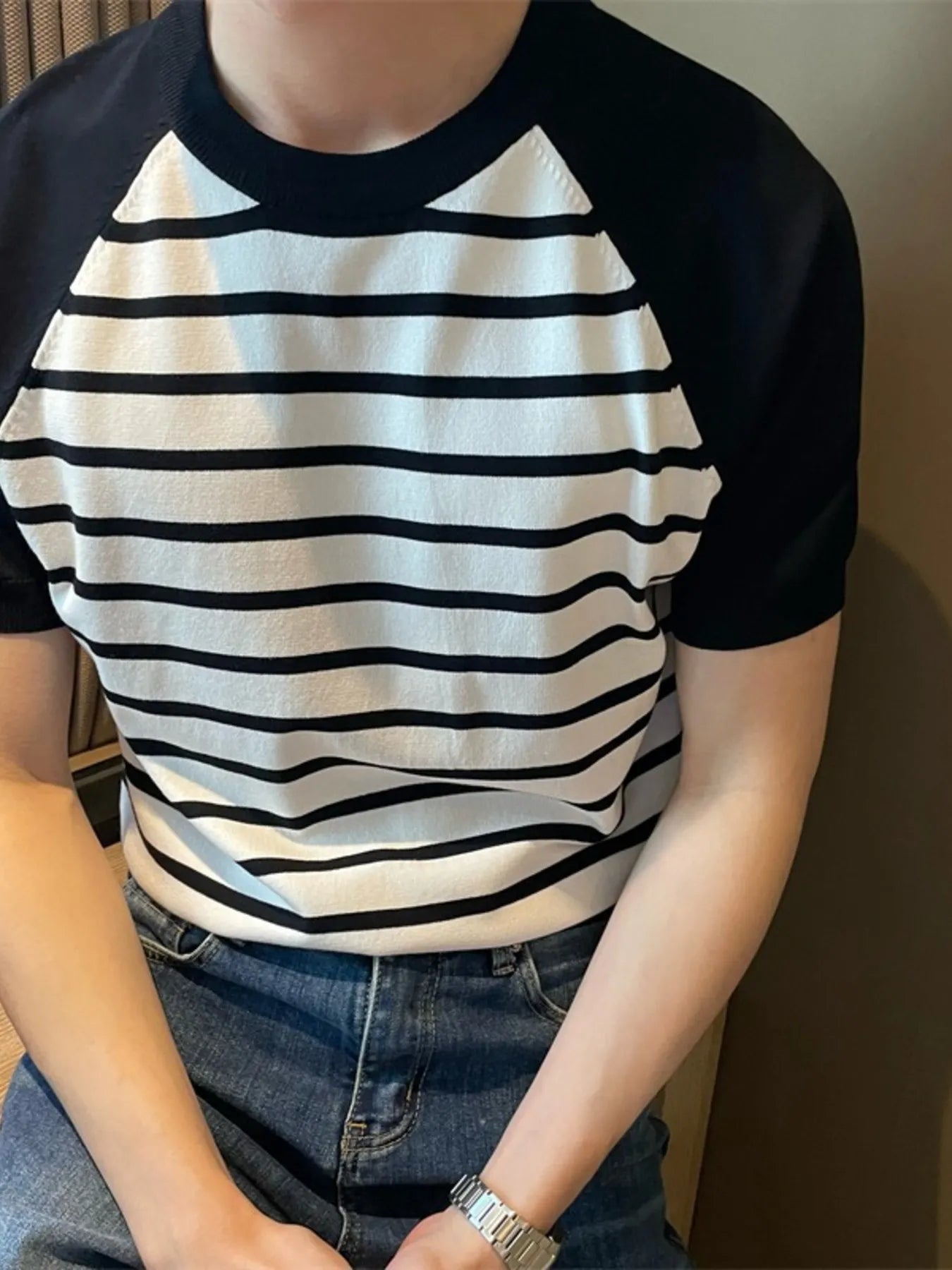 Close-up of striped and raglan sleeve design on T-shirt