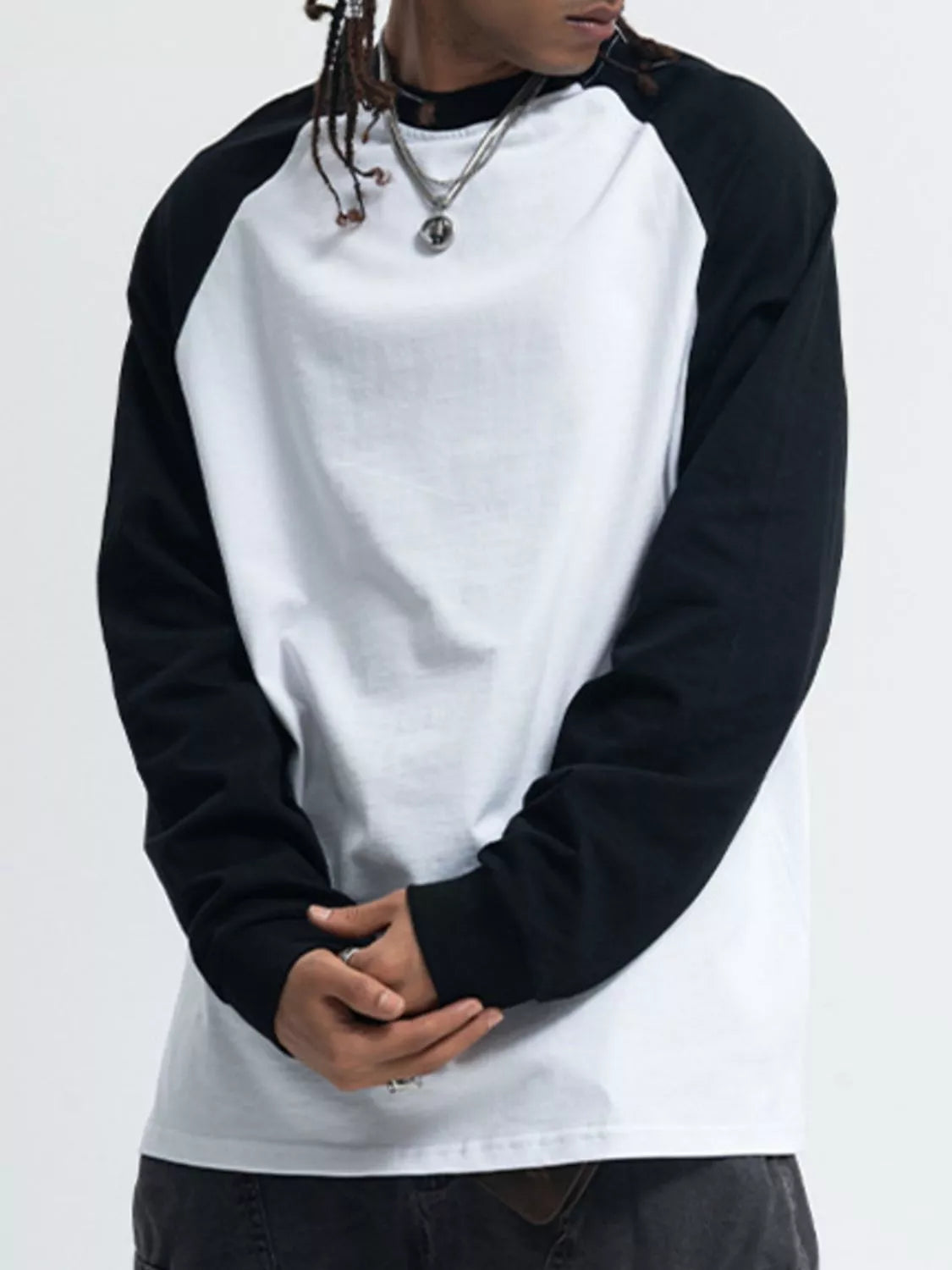 Model wearing raglan sleeve round neck long sleeve T-shirt styled casually