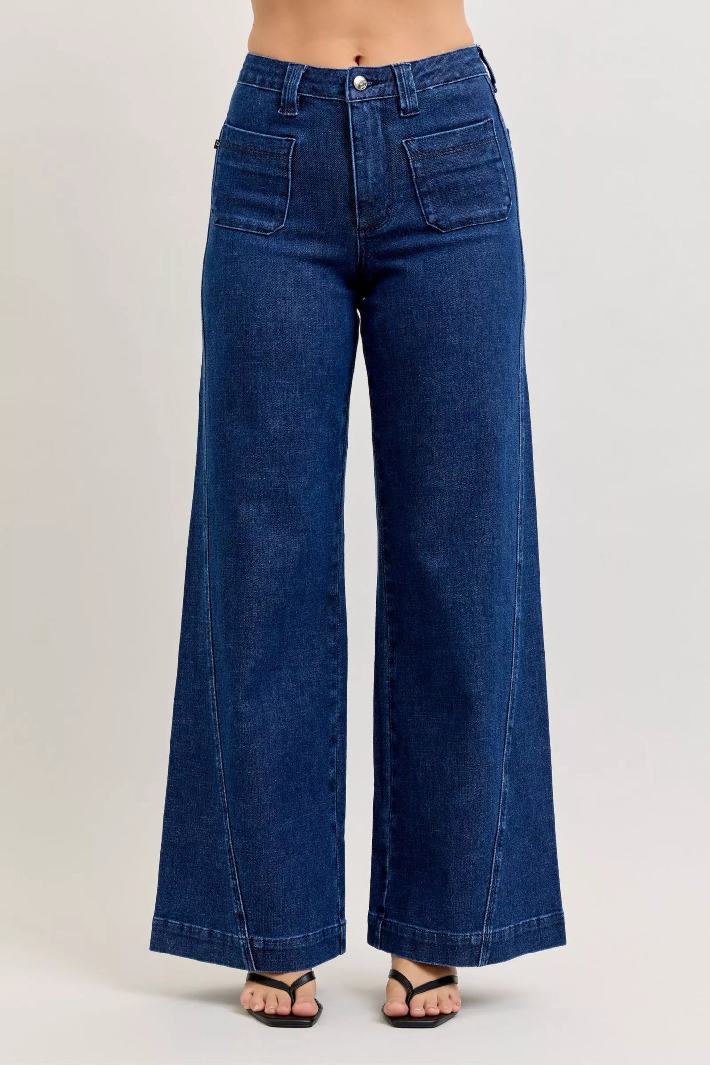 Front view of high-waisted retro wide jeans with patch pockets and twisted seams