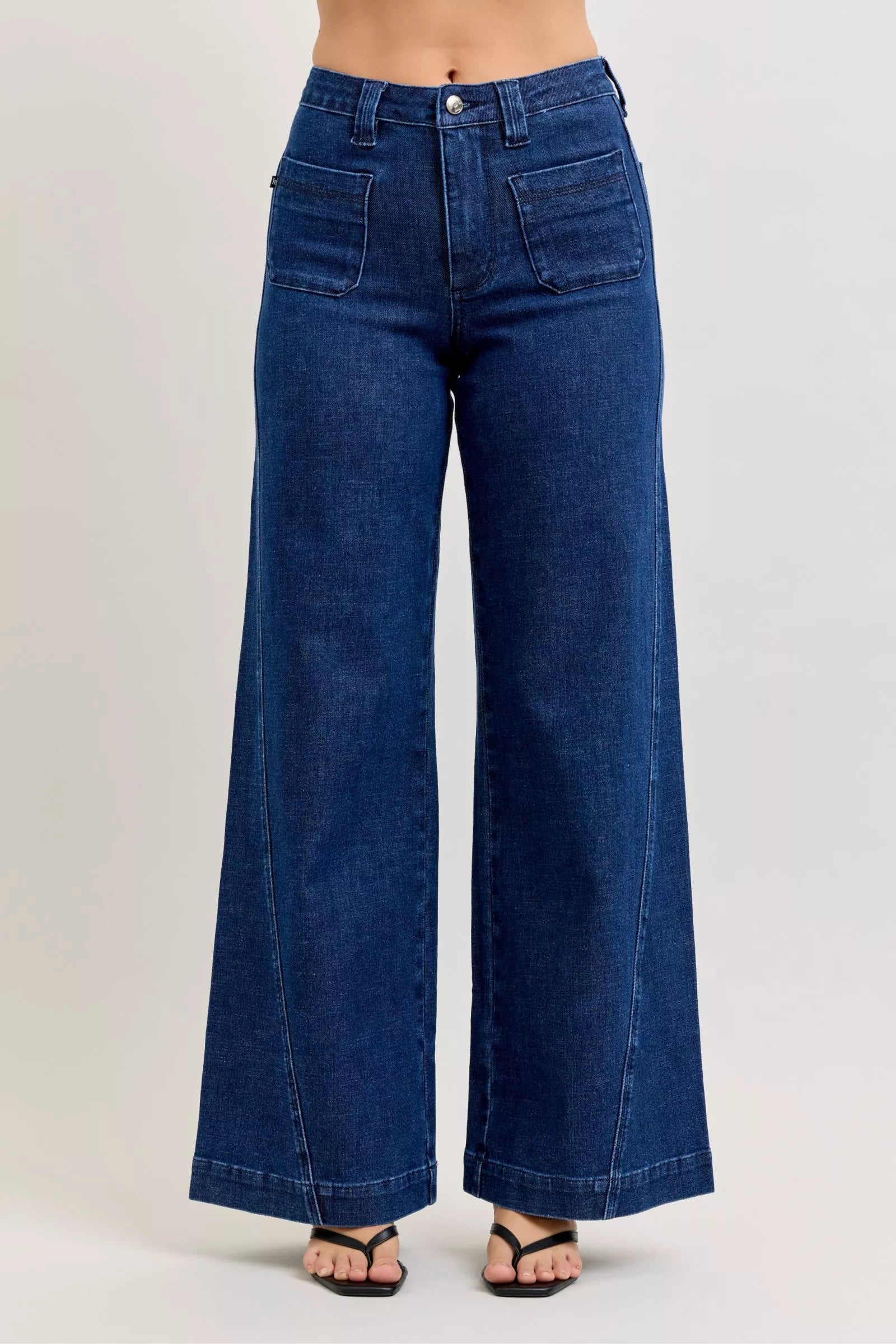 Front view of high-waisted retro wide jeans with patch pockets and twisted seams