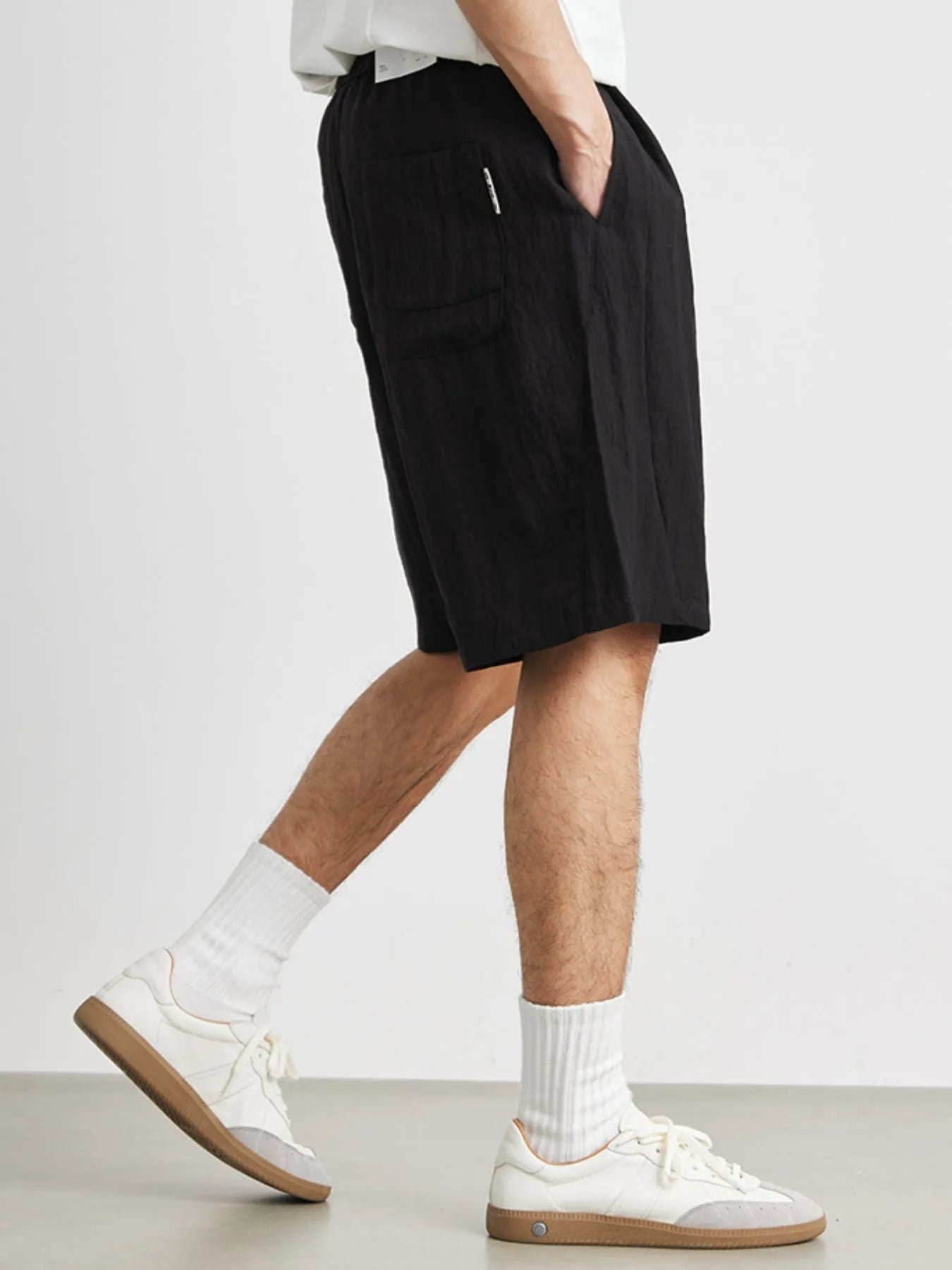 Close-up of ruched texture and drawstring detail on shorts