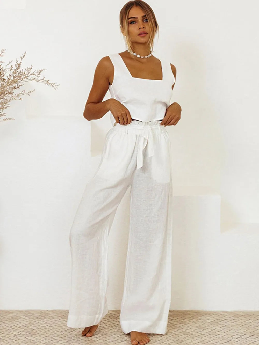 Model wearing the cotton two-piece set styled for a luxury resort look