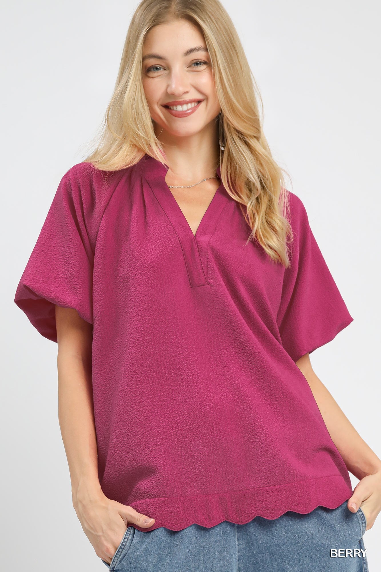 Front view of textured blouse with scalloped hem
