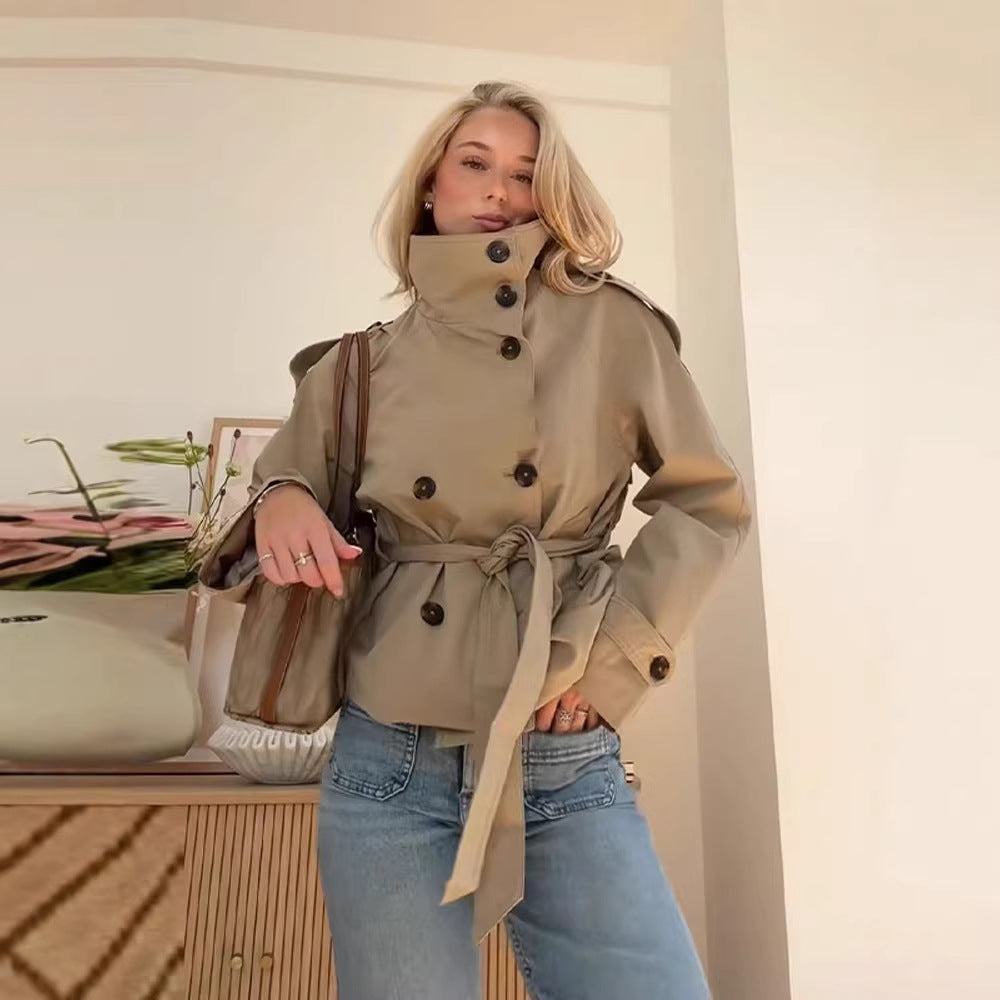 Rear view of the short trench coat on a mannequin showcasing the waist-cinching belt and structured back panel