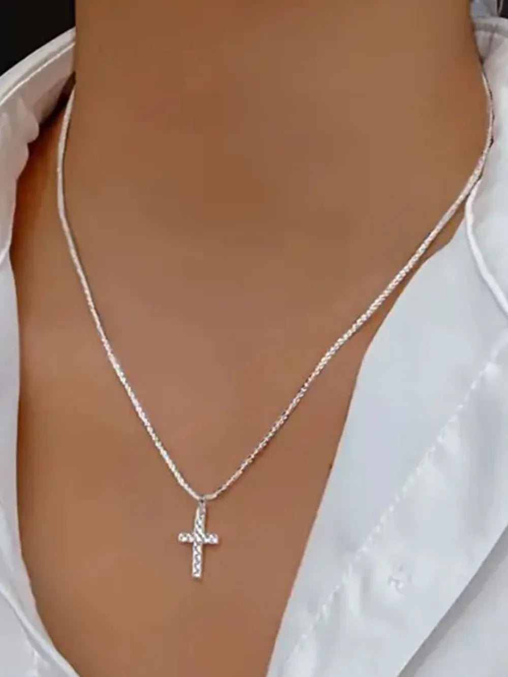 Close-up of the 925 hallmark and the luminous polished surface of the silver cross