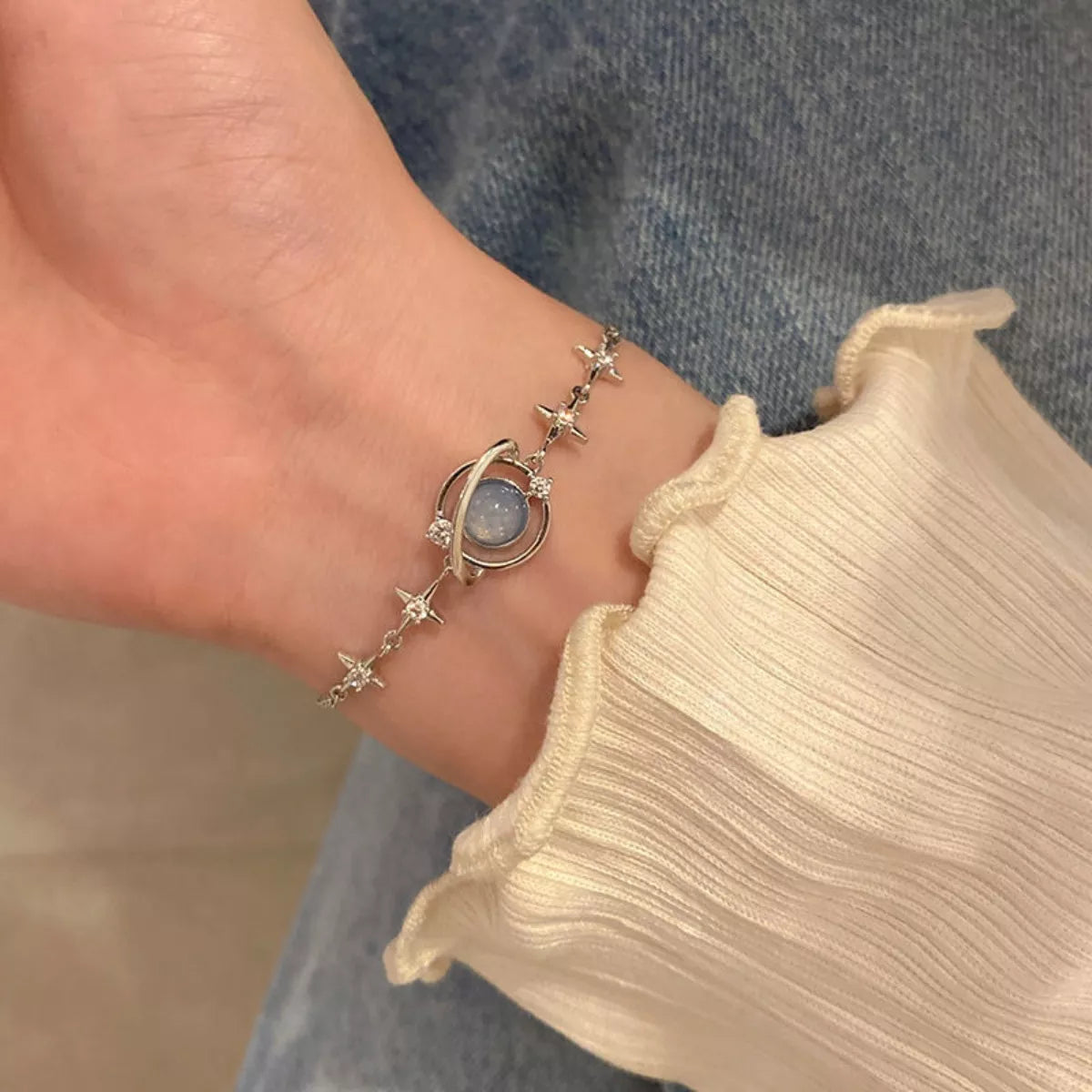 Front view of the platinum-plated 925 sterling silver bracelet with planet charm