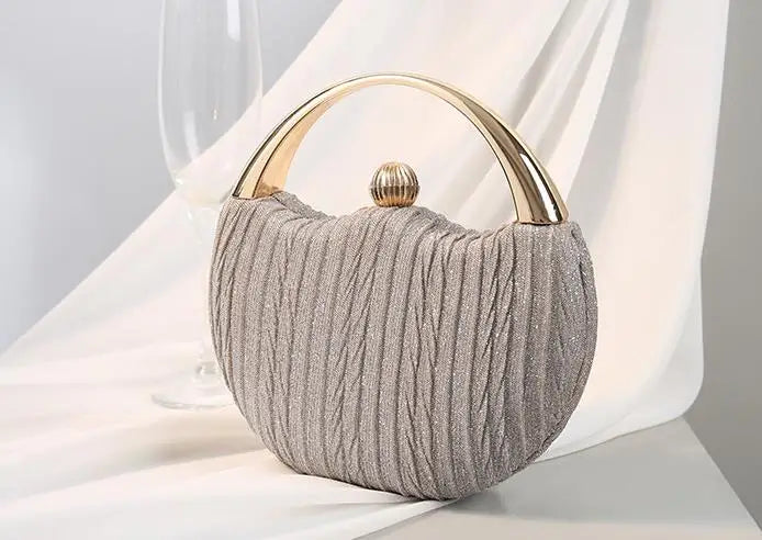 silver round clutch bag with metal handle minimalist luxury