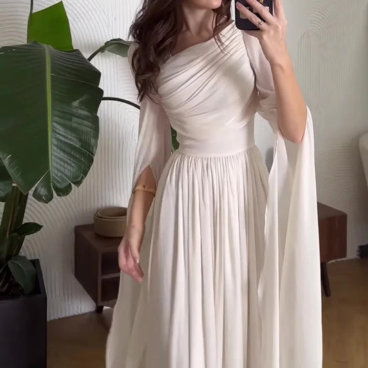 Front view of the solid black slant-shoulder gown with draped detailing