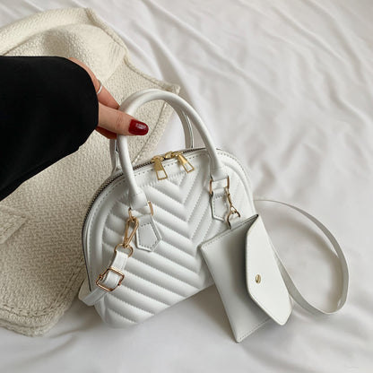 Close-up of the integrated soft carry handle and the high-standard single shoulder strap finish