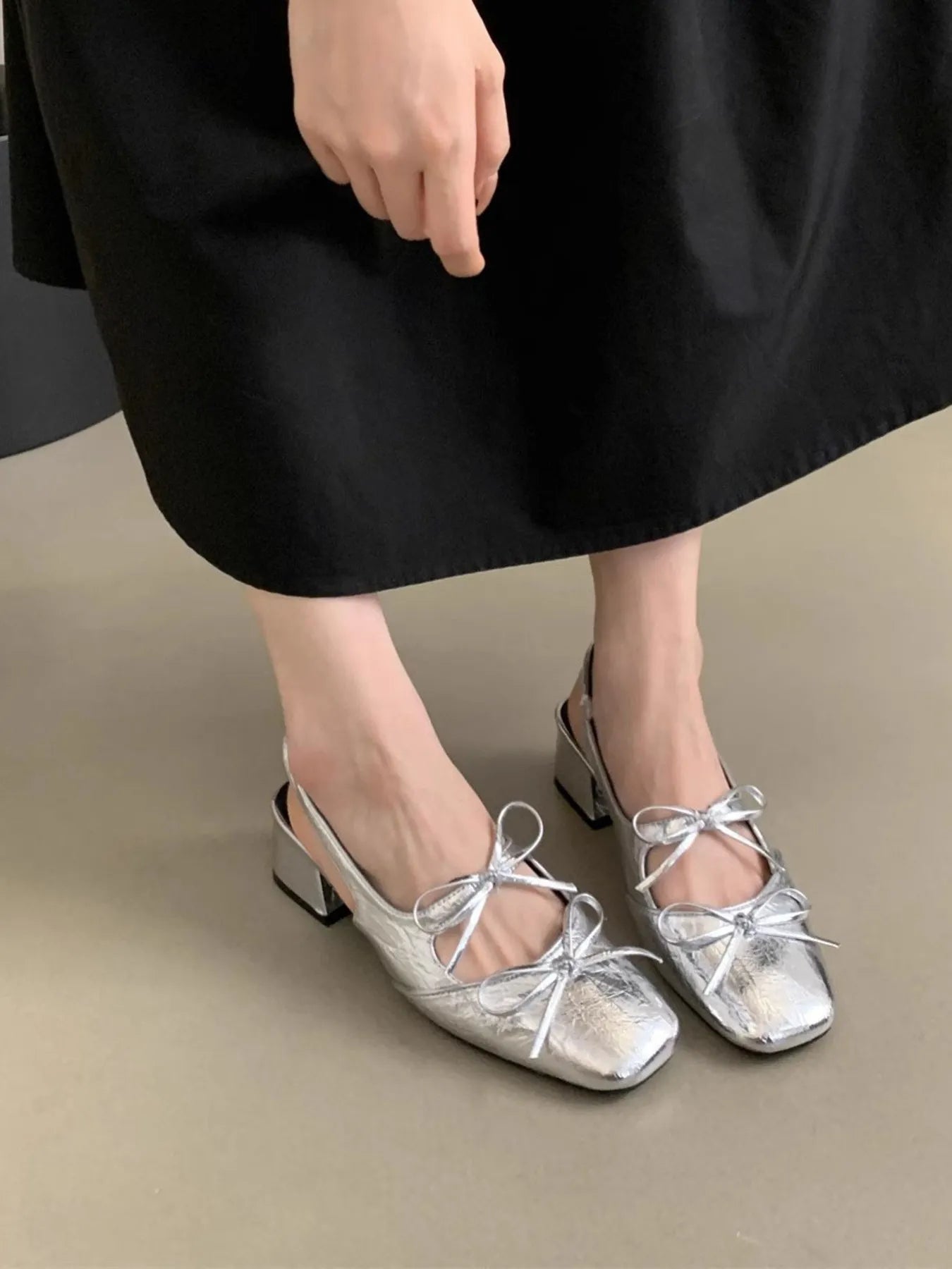 Close-up of the architectural square toe and delicate bow-tie construction