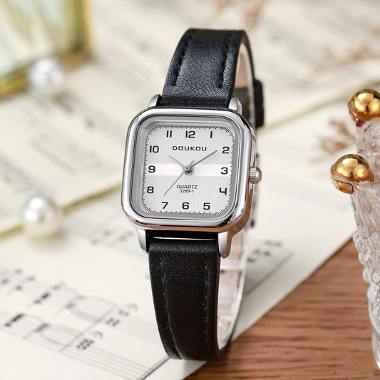 Front view of the square-shaped watch showcasing the clean dial, Arabic numerals, and steel strip band