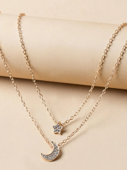 Close-up of the intricate crescent moon, star charms, and shimmering zircon accents