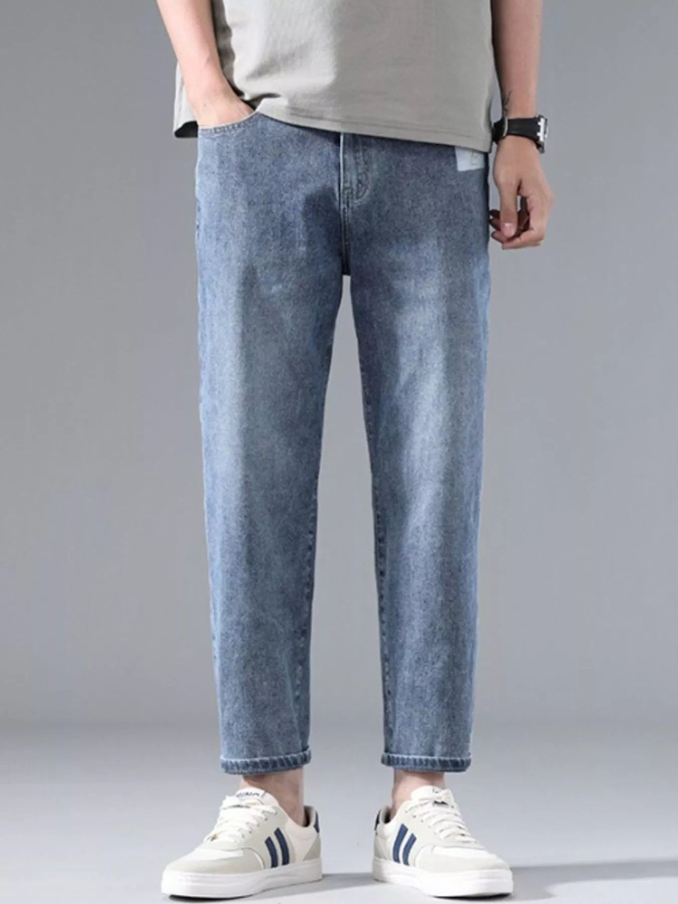Model wearing straight leg washed jeans styled casually