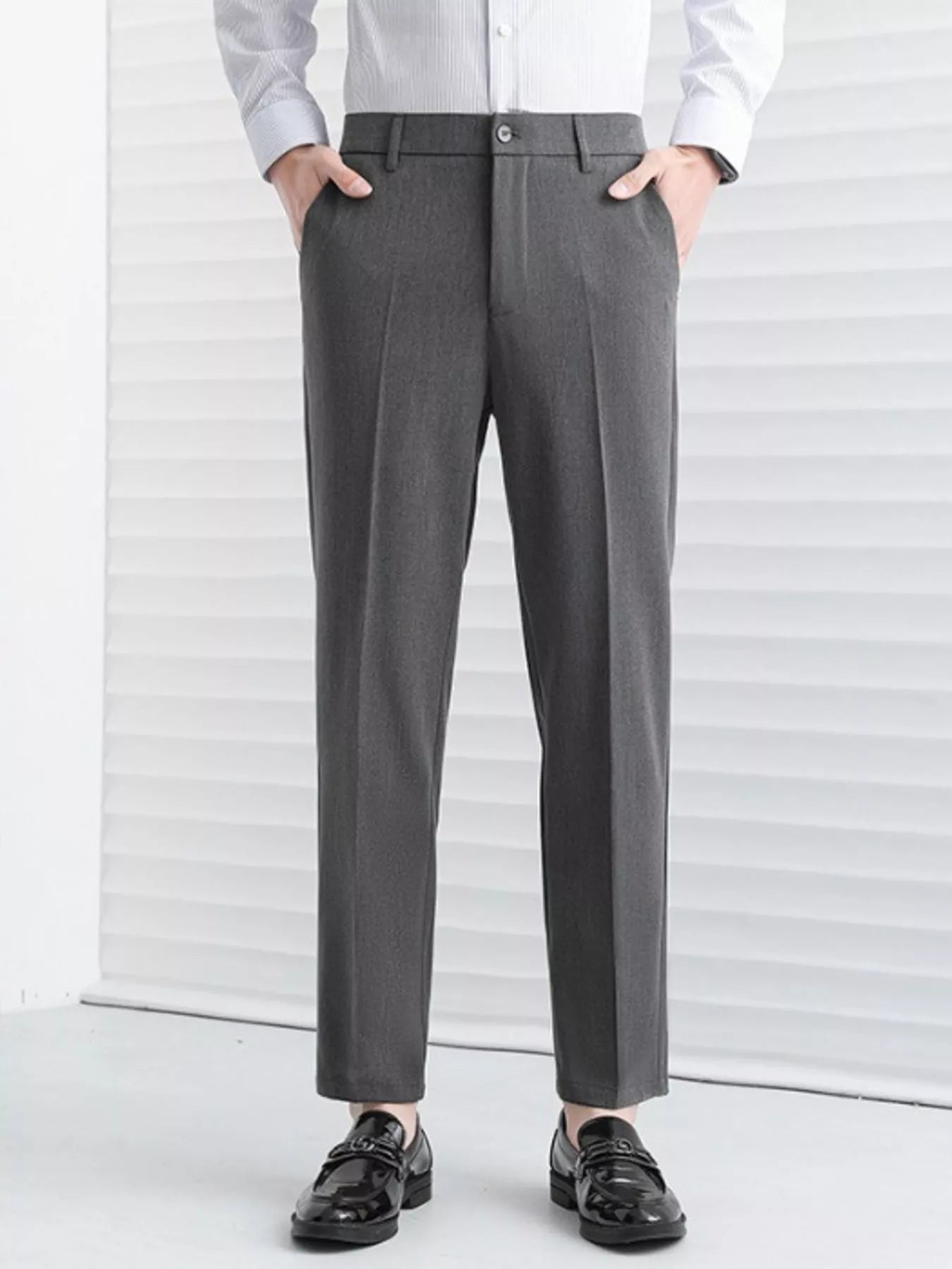 Model wearing straight leg tailored pants styled casually