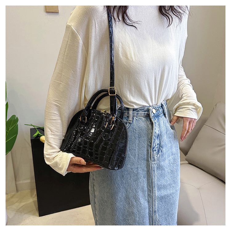 Model carrying the minimalist shell messenger bag styled for a high-profile city commute