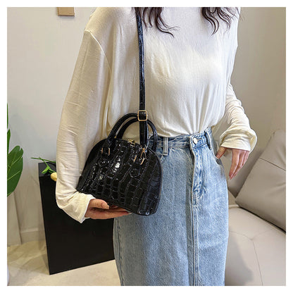 Model carrying the minimalist shell messenger bag styled for a high-profile city commute