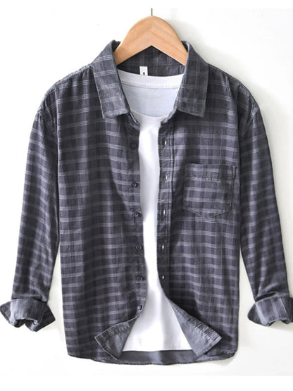 Model wearing striped cotton blend button-up shirt styled casually