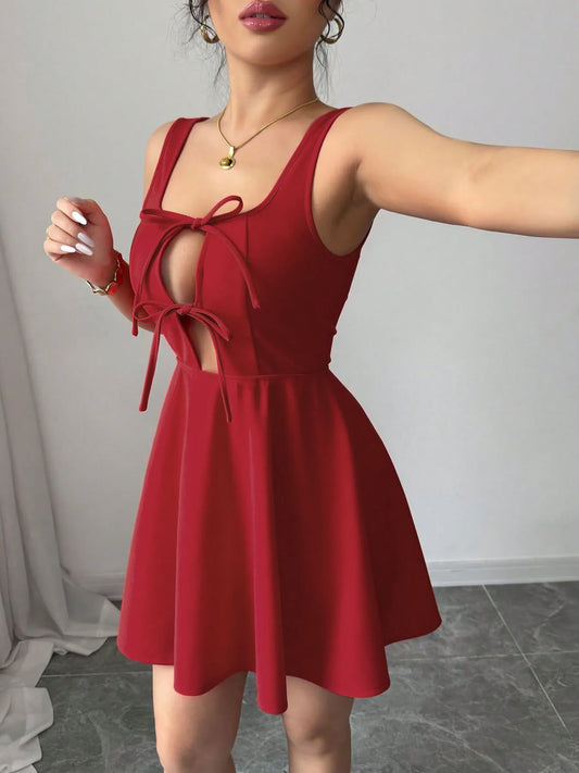 Front view of the tie-front wide strap dress with architectural cutouts