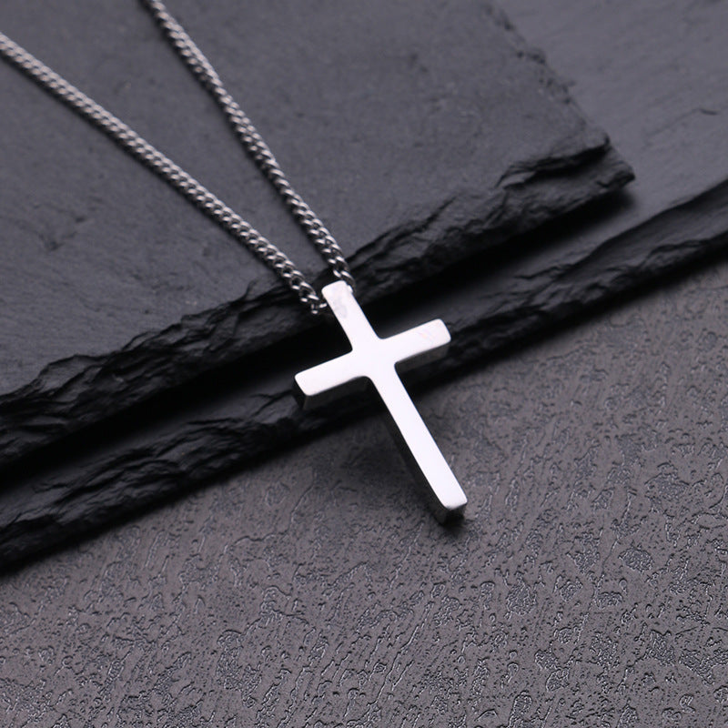 Front view of the high-polished titanium steel cross pendant on a box chain