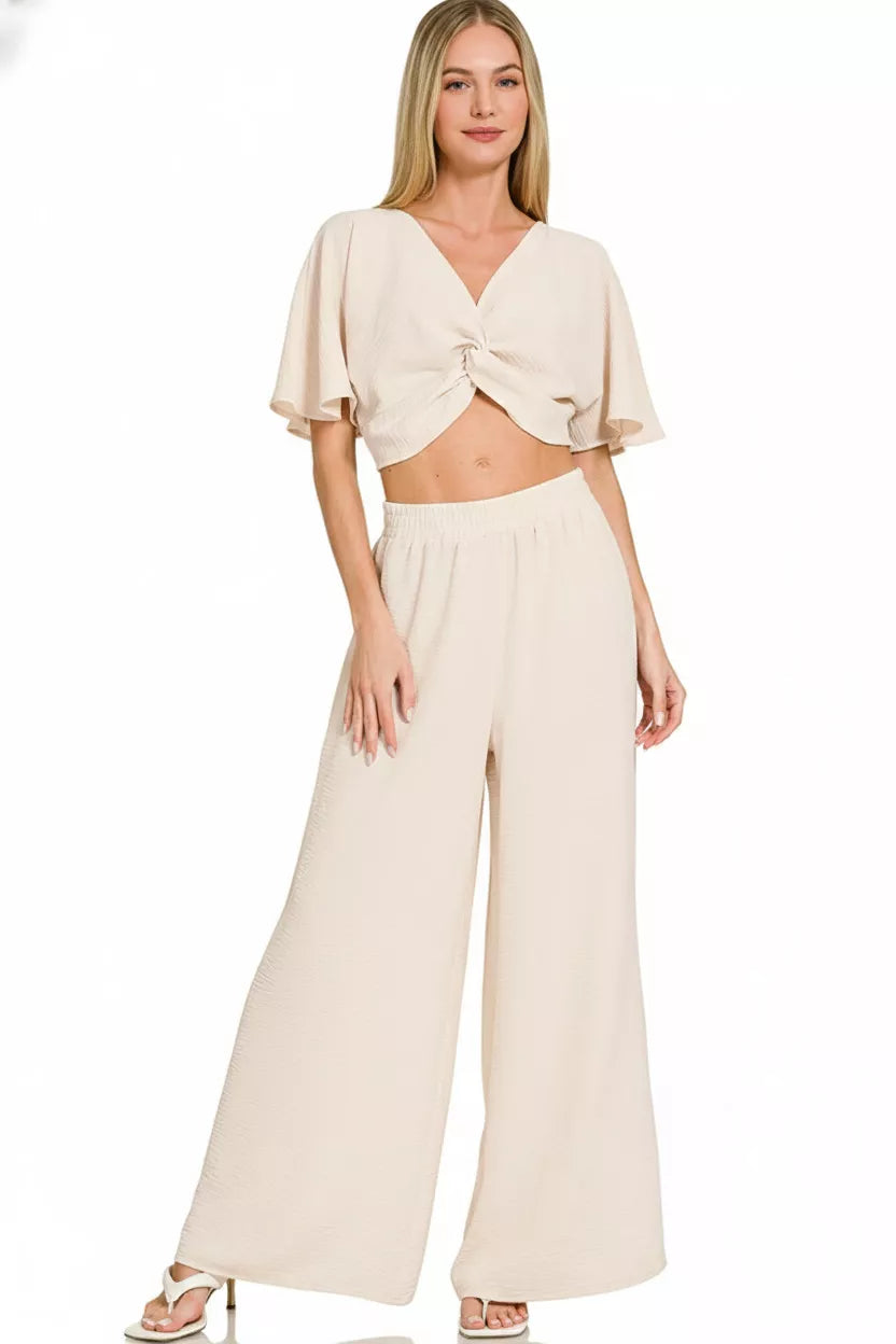 Model wearing airflow twisted top and wide leg pants set styled elegantly