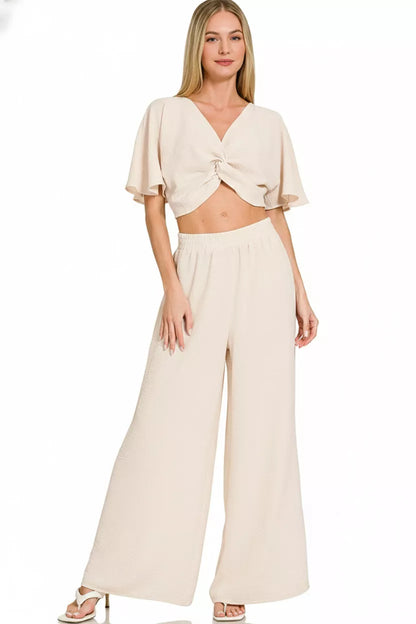 Model wearing airflow twisted top and wide leg pants set styled elegantly