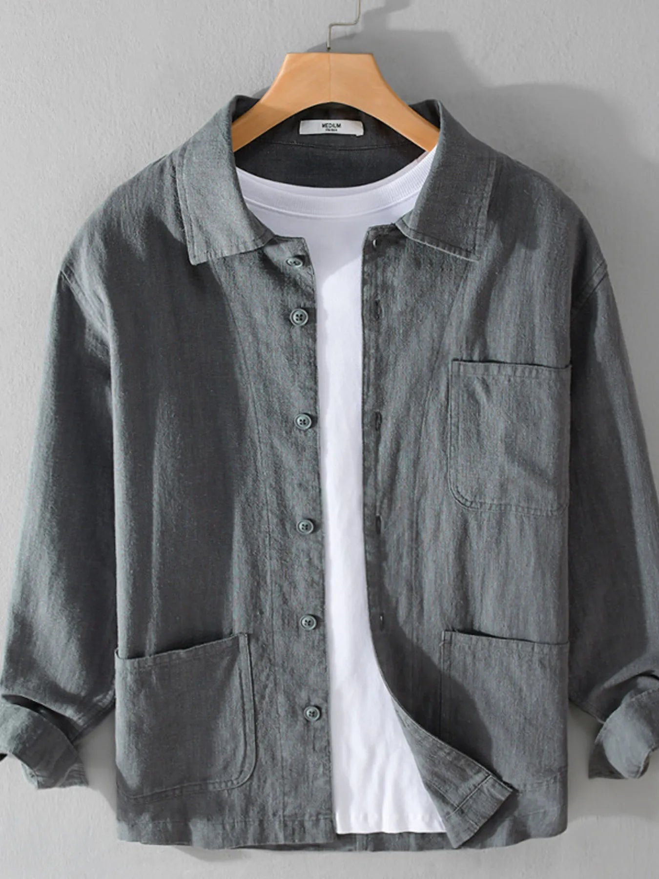 Model wearing washed linen-blend button-up shirt styled casually