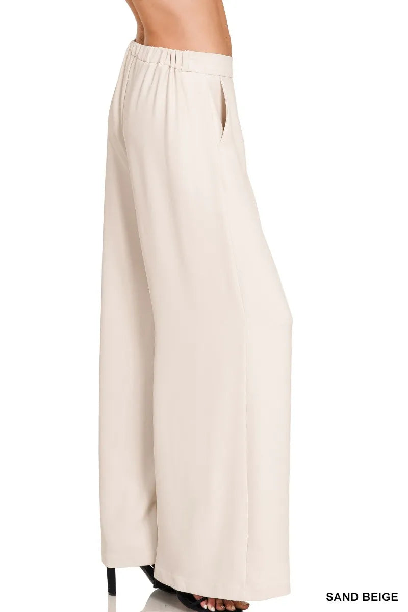 Model wearing elastic waist wide leg pants styled with a structured blazer