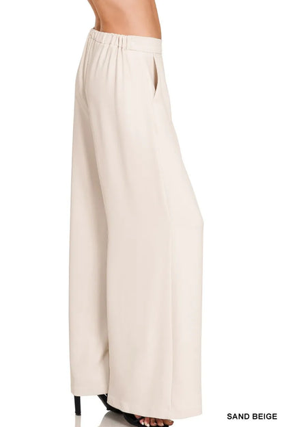 Model wearing elastic waist wide leg pants styled with a structured blazer