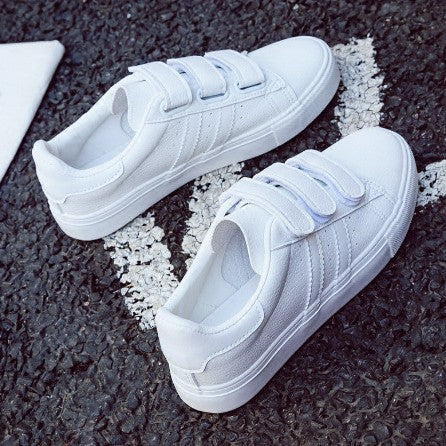 Side view of the white magic strap shoe showcasing the minimalist design and 2cm rubber sole