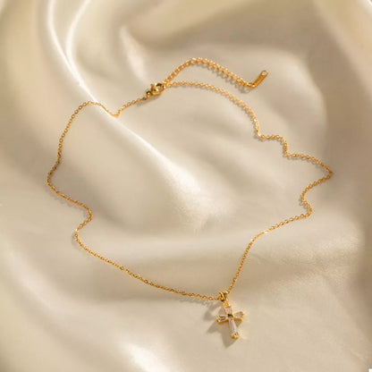 Close up of zircon stones on gold cross pendant necklace